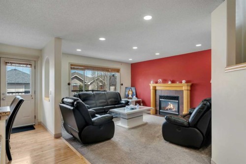 133 Everwoods Close Sw, Calgary, AB - Indoor Photo Showing Living Room With Fireplace