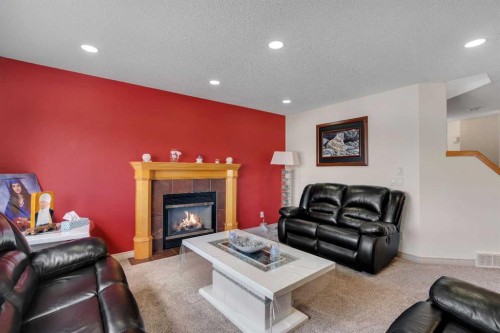 133 Everwoods Close Sw, Calgary, AB - Indoor Photo Showing Living Room With Fireplace