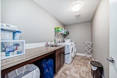 88 Masters Way Se, Calgary, AB - Indoor Photo Showing Laundry Room
