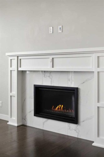48 Evansfield Manor Nw, Calgary, AB - Indoor Photo Showing Living Room With Fireplace