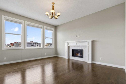 48 Evansfield Manor Nw, Calgary, AB - Indoor Photo Showing Living Room With Fireplace