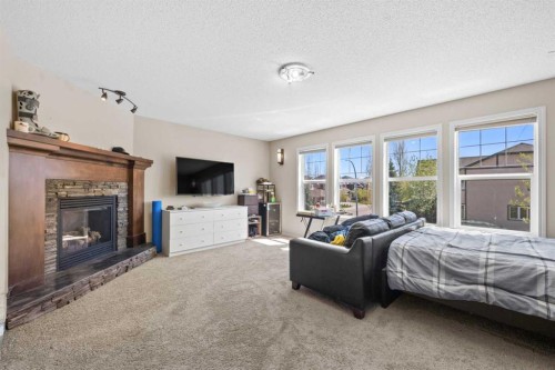 16 Cranarch Grove Se, Calgary, AB - Indoor Photo Showing Bedroom With Fireplace