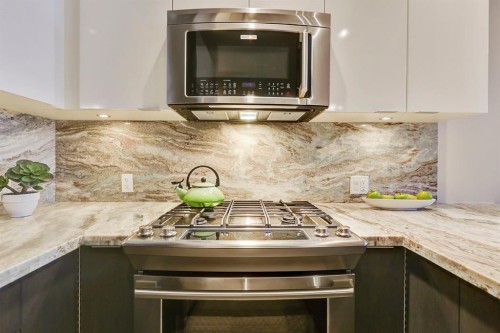 119 Confluence Mews Se, Calgary, AB - Indoor Photo Showing Kitchen With Upgraded Kitchen