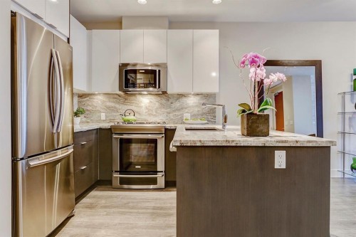 119 Confluence Mews Se, Calgary, AB - Indoor Photo Showing Kitchen With Stainless Steel Kitchen With Upgraded Kitchen