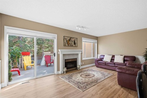 55 Cedarview Mews Sw, Calgary, AB - Indoor Photo Showing Living Room With Fireplace