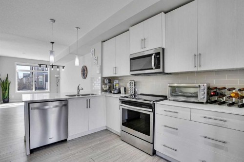 104 Legacy Path Se, Calgary, AB - Indoor Photo Showing Kitchen With Stainless Steel Kitchen With Double Sink With Upgraded Kitchen