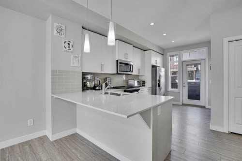 104 Legacy Path Se, Calgary, AB - Indoor Photo Showing Kitchen With Stainless Steel Kitchen With Double Sink