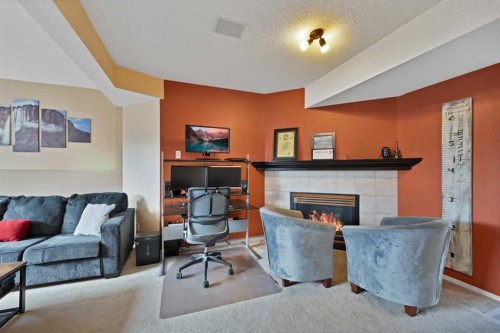 147 Harvest Oak Crescent Ne, Calgary, AB - Indoor Photo Showing Living Room With Fireplace