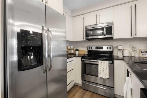 3107-11 Mahogany Row Se, Calgary, AB - Indoor Photo Showing Kitchen With Stainless Steel Kitchen With Upgraded Kitchen