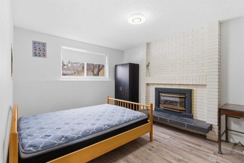5048 Dalhart Road Nw, Calgary, AB - Indoor Photo Showing Bedroom With Fireplace