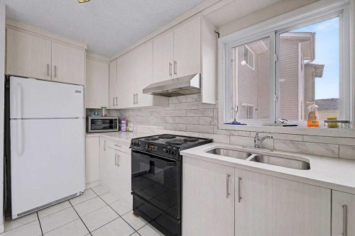 48 Whitworth Way Ne, Calgary, AB - Indoor Photo Showing Kitchen With Double Sink
