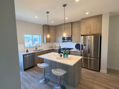 224 River Heights Drive, Cochrane, AB - Indoor Photo Showing Kitchen With Stainless Steel Kitchen With Double Sink With Upgraded Kitchen