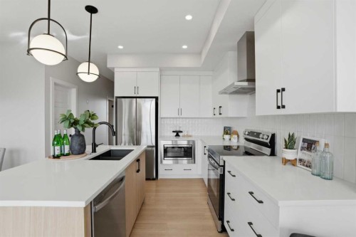 85 Wild Rose Way Se, Calgary, AB - Indoor Photo Showing Kitchen With Stainless Steel Kitchen With Double Sink With Upgraded Kitchen