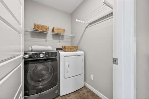 205 Sunset Point, Cochrane, AB - Indoor Photo Showing Laundry Room