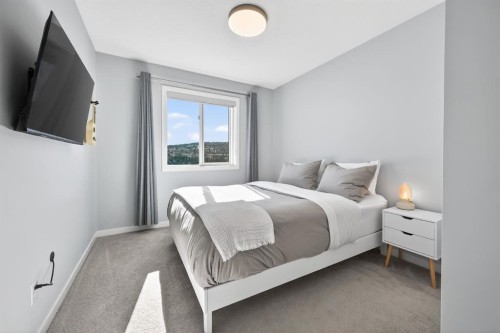 205 Sunset Point, Cochrane, AB - Indoor Photo Showing Bedroom
