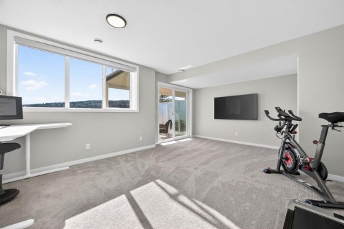 205 Sunset Point, Cochrane, AB - Indoor Photo Showing Gym Room