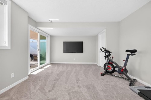 205 Sunset Point, Cochrane, AB - Indoor Photo Showing Gym Room