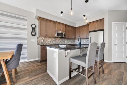 205 Sunset Point, Cochrane, AB - Indoor Photo Showing Kitchen With Upgraded Kitchen