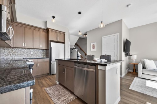 205 Sunset Point, Cochrane, AB - Indoor Photo Showing Kitchen With Upgraded Kitchen