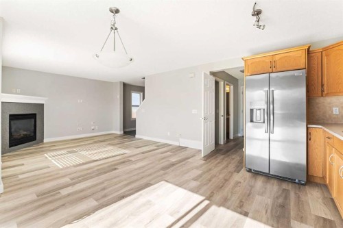 185 Copperfield Common Se, Calgary, AB - Indoor Photo Showing Kitchen With Fireplace