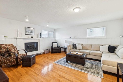 87 Edforth Road Nw, Calgary, AB - Indoor Photo Showing Living Room With Fireplace