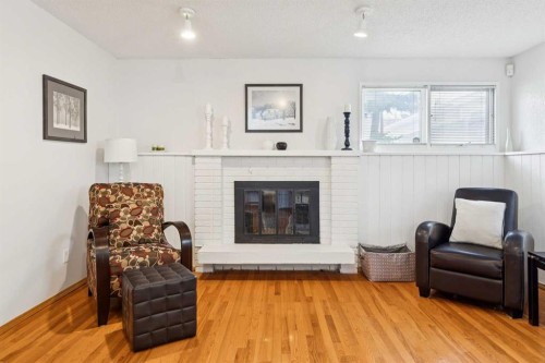 87 Edforth Road Nw, Calgary, AB - Indoor Photo Showing Living Room With Fireplace