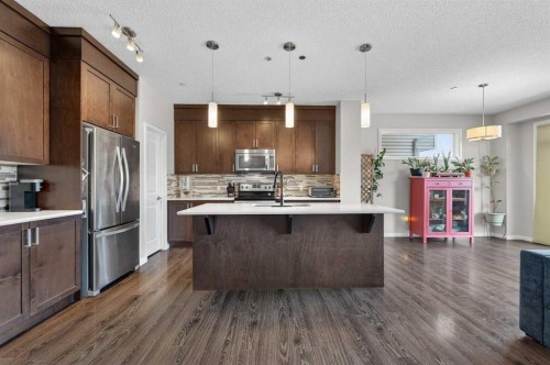 15 Fireside Crescent, Cochrane, AB - Indoor Photo Showing Kitchen With Upgraded Kitchen
