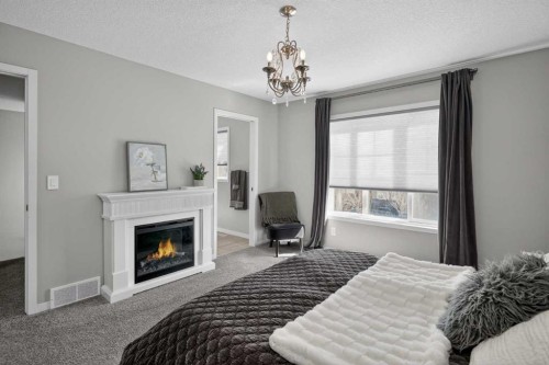 31 Lucas Boulevard Nw, Calgary, AB - Indoor Photo Showing Bedroom With Fireplace