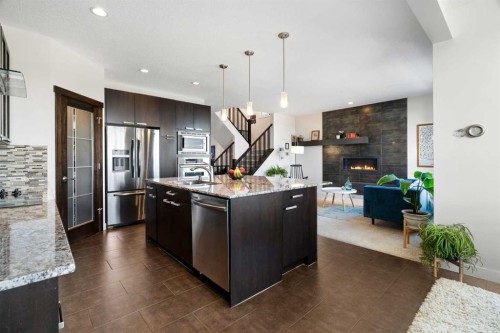 61 Cougar Ridge Cove Sw, Calgary, AB - Indoor Photo Showing Kitchen With Fireplace With Stainless Steel Kitchen With Upgraded Kitchen