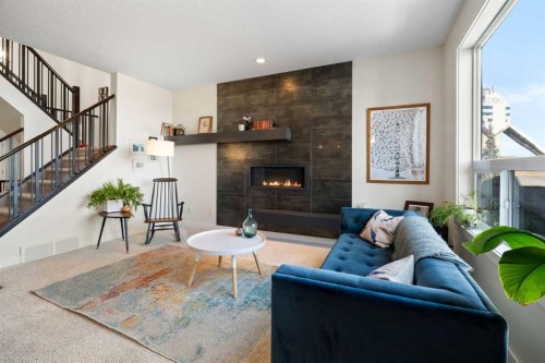 61 Cougar Ridge Cove Sw, Calgary, AB - Indoor Photo Showing Living Room With Fireplace