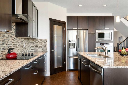 61 Cougar Ridge Cove Sw, Calgary, AB - Indoor Photo Showing Kitchen With Stainless Steel Kitchen With Double Sink With Upgraded Kitchen