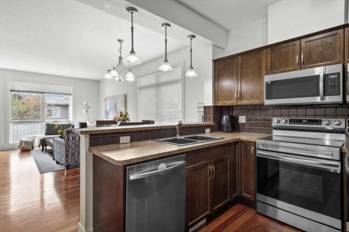 1-164 Rockyledge View Nw, Calgary, AB - Indoor Photo Showing Kitchen With Double Sink