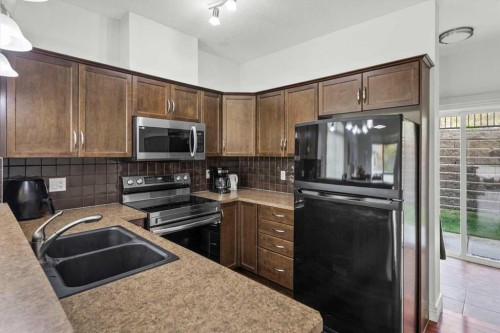 1-164 Rockyledge View Nw, Calgary, AB - Indoor Photo Showing Kitchen With Double Sink