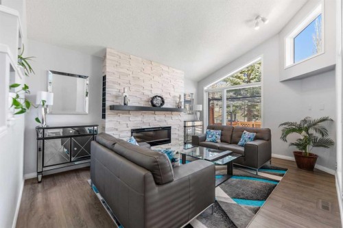 114 Rocky Ridge Green Nw, Calgary, AB - Indoor Photo Showing Living Room With Fireplace