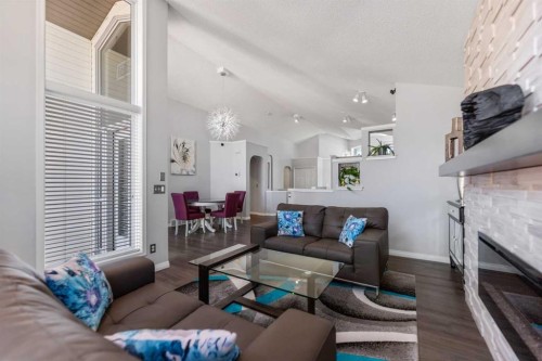 114 Rocky Ridge Green Nw, Calgary, AB - Indoor Photo Showing Living Room With Fireplace