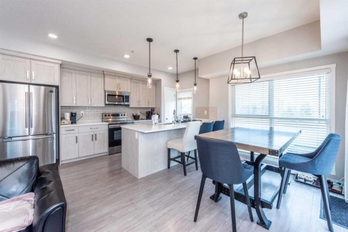 116-4350 Seton Drive Se, Calgary, AB - Indoor Photo Showing Kitchen With Stainless Steel Kitchen With Upgraded Kitchen