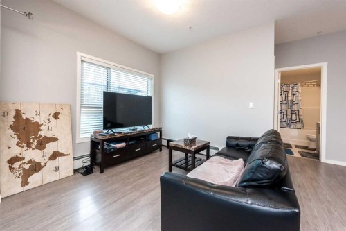 116-4350 Seton Drive Se, Calgary, AB - Indoor Photo Showing Living Room