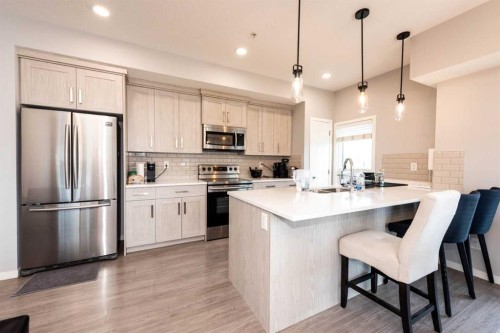 116-4350 Seton Drive Se, Calgary, AB - Indoor Photo Showing Kitchen With Stainless Steel Kitchen With Upgraded Kitchen