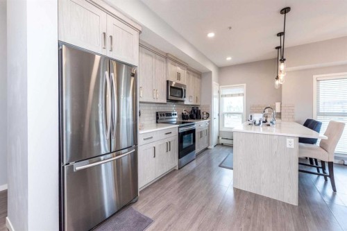 116-4350 Seton Drive Se, Calgary, AB - Indoor Photo Showing Kitchen With Stainless Steel Kitchen With Upgraded Kitchen