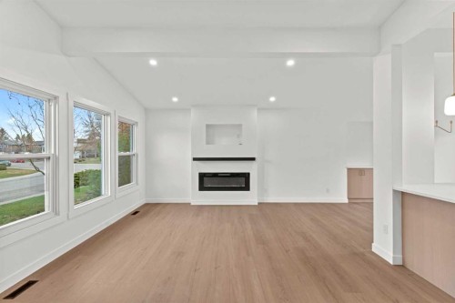 212 Queen Anne Road Se, Calgary, AB - Indoor Photo Showing Living Room With Fireplace