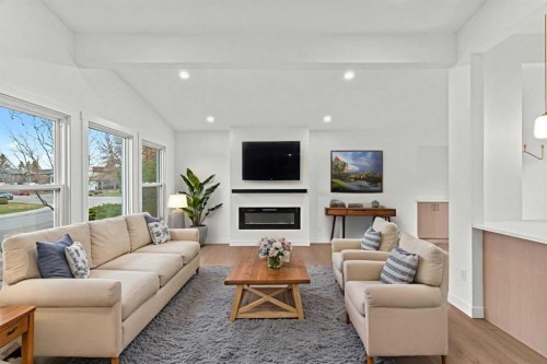 212 Queen Anne Road Se, Calgary, AB - Indoor Photo Showing Living Room With Fireplace