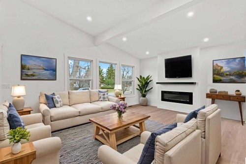 212 Queen Anne Road Se, Calgary, AB - Indoor Photo Showing Living Room With Fireplace
