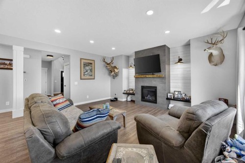 10 Bishop Circle, Carstairs, AB - Indoor Photo Showing Living Room With Fireplace