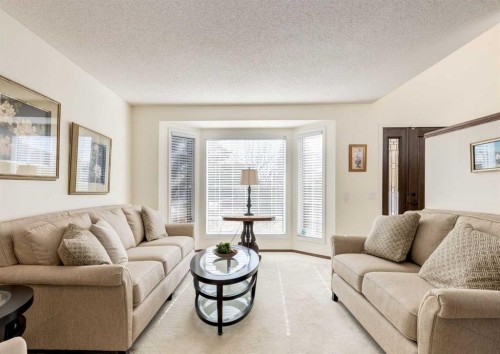 83 Gleneagles Close, Cochrane, AB - Indoor Photo Showing Living Room