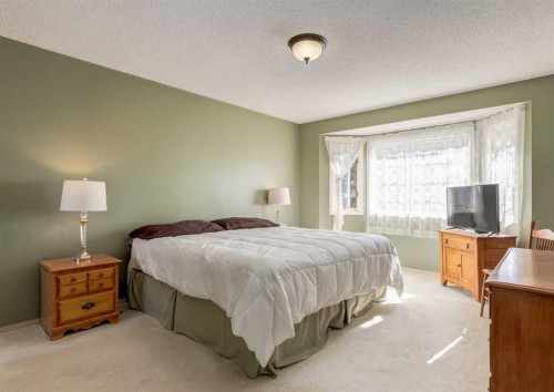 83 Gleneagles Close, Cochrane, AB - Indoor Photo Showing Bedroom