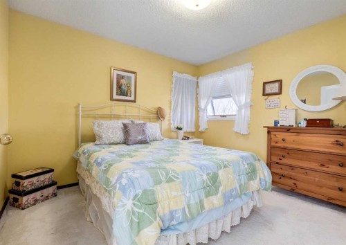 83 Gleneagles Close, Cochrane, AB - Indoor Photo Showing Bedroom