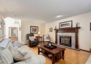 83 Gleneagles Close, Cochrane, AB  - Indoor Photo Showing Living Room With Fireplace 