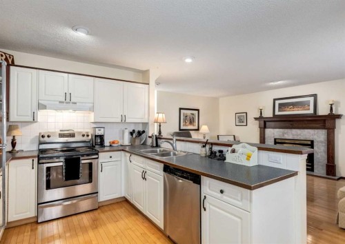 83 Gleneagles Close, Cochrane, AB - Indoor Photo Showing Kitchen With Double Sink