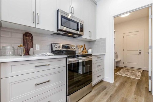 432 Rivercrest Road, Cochrane, AB - Indoor Photo Showing Kitchen With Upgraded Kitchen