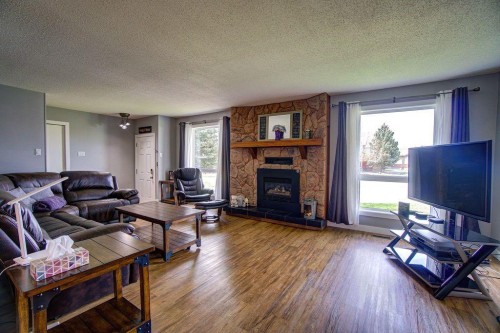 5338 5 Street West, Claresholm, AB - Indoor Photo Showing Living Room With Fireplace